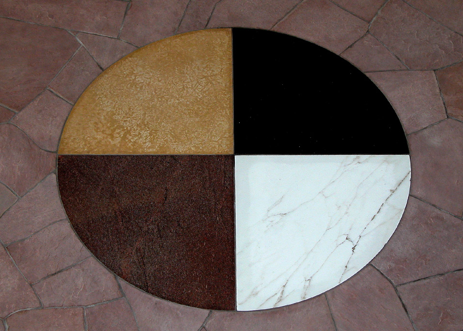 Floor tiling in building that represents the medicine wheel and the four sacred directions
