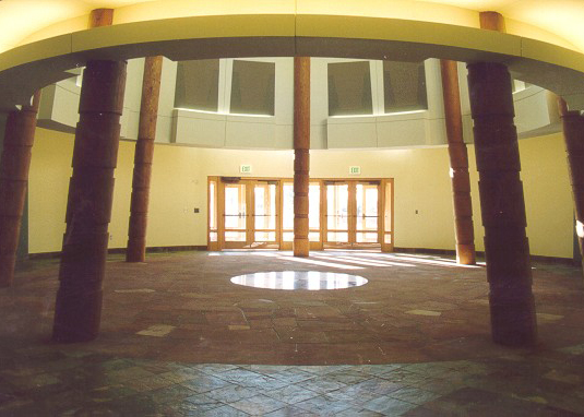 Interior of the building showcasing the rotunda, a circular room outlined by tipi poles
