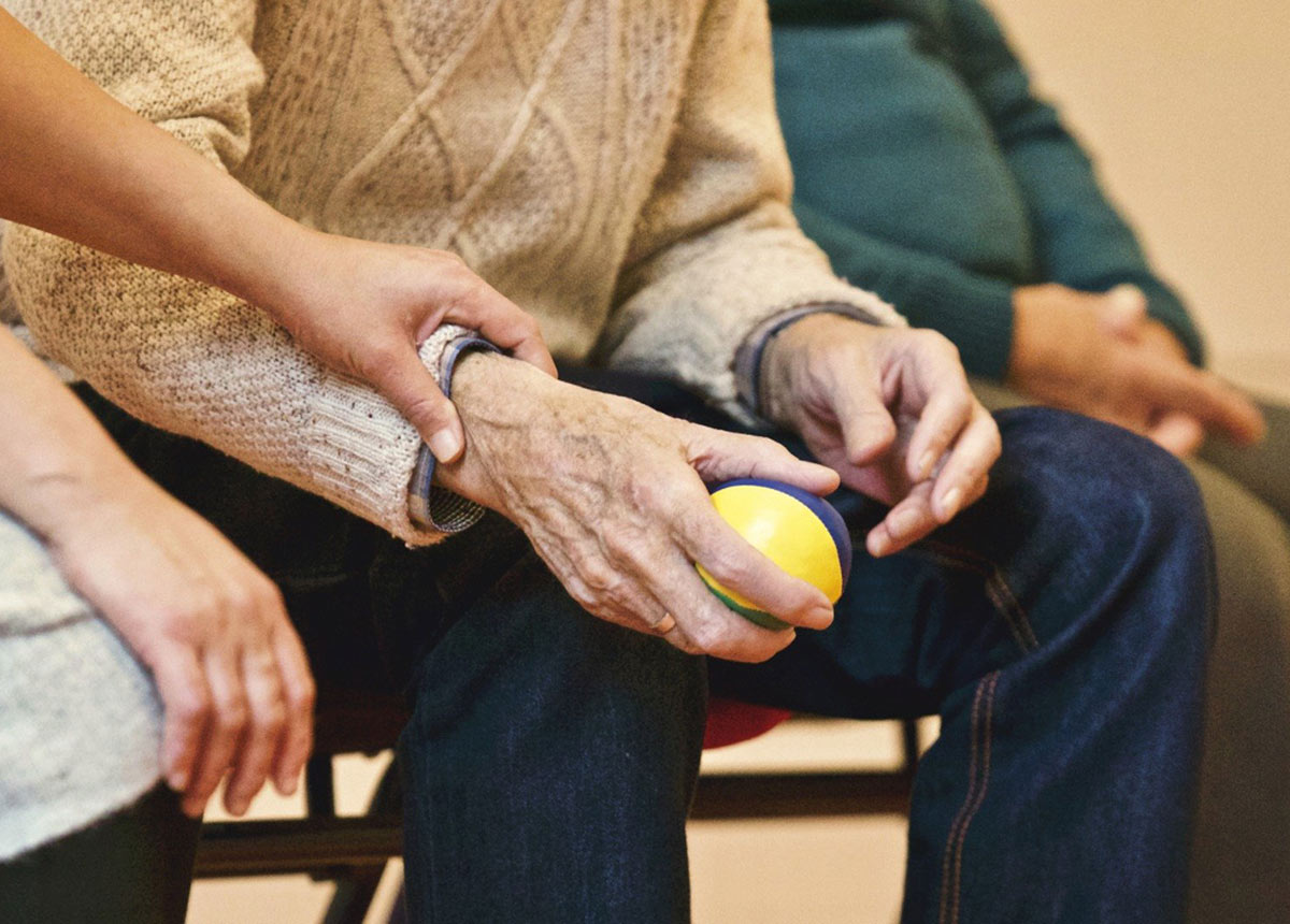 older adult holding a ball
