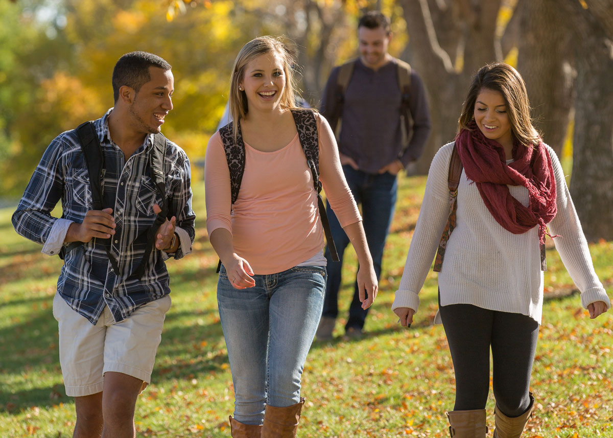 three students walking on UNC campus