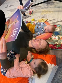 Liliana Tenney reads with her daughters at home in-between meetings