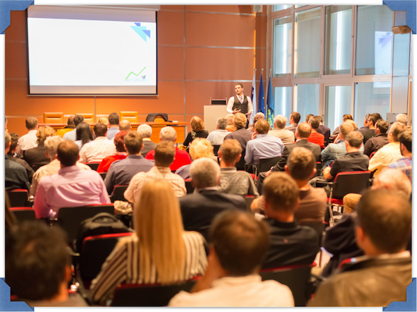 Photo of someone presenting to a crowd