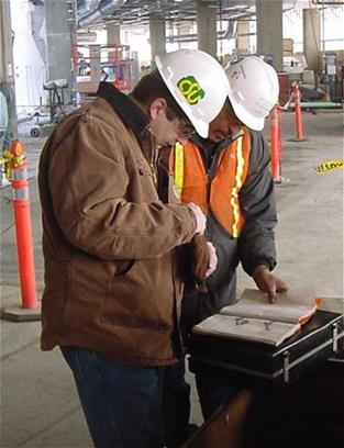 Mike Van Dyke working at the CSU OSHA program wearing a hard hat