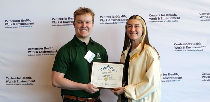 Hannah Nauth, AIHA RMS president, presents Thomas Michak the HP Poster Award.