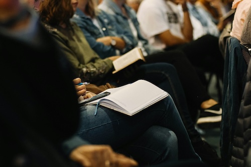 Photo of people sitting at a conference