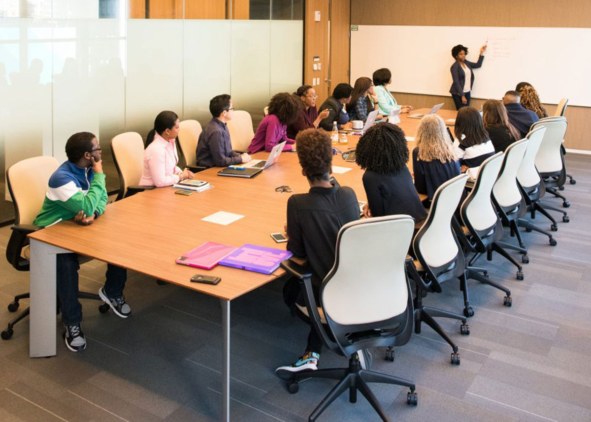 group of people in a meeting sitting at a conference table