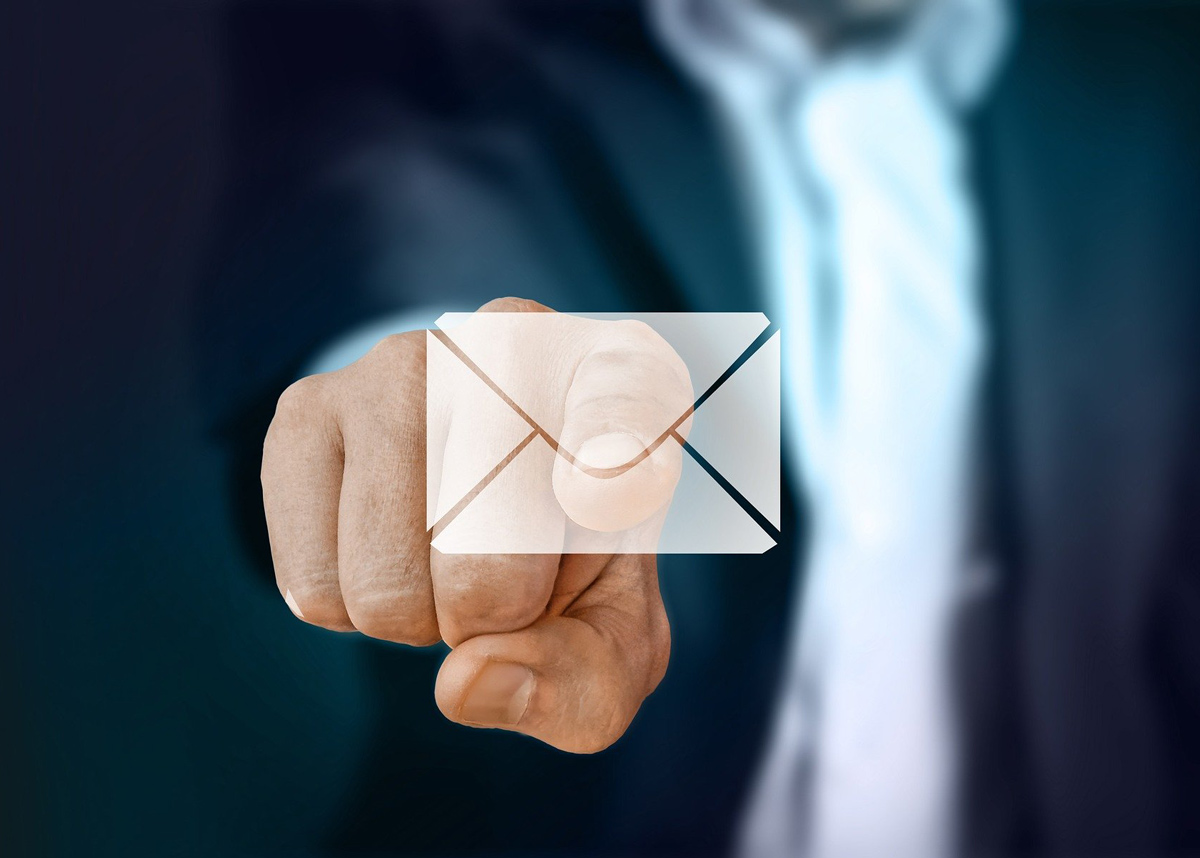 man using finger to point at an email icon
