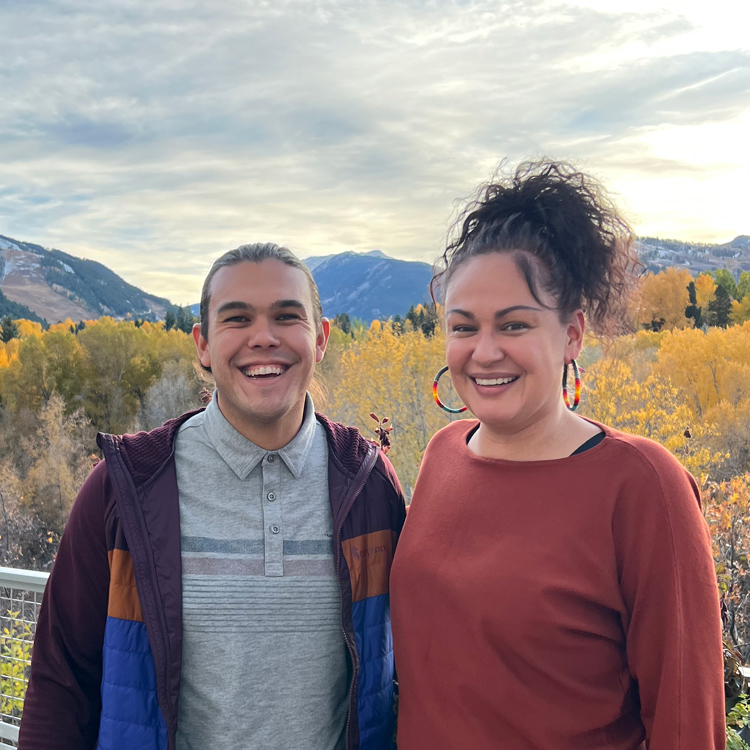 Jerreed and Cory with yellow-leafed aspen trees and mountains in the background