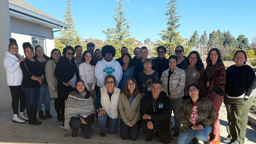 People standing posed outside post-training in California