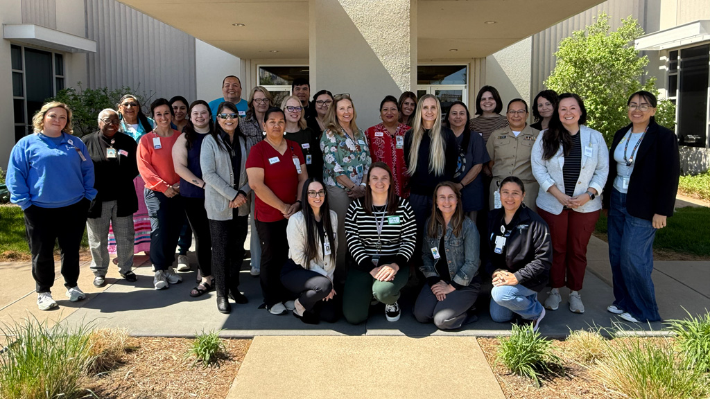 People standing posed in front of a building post-training in Oklahoma