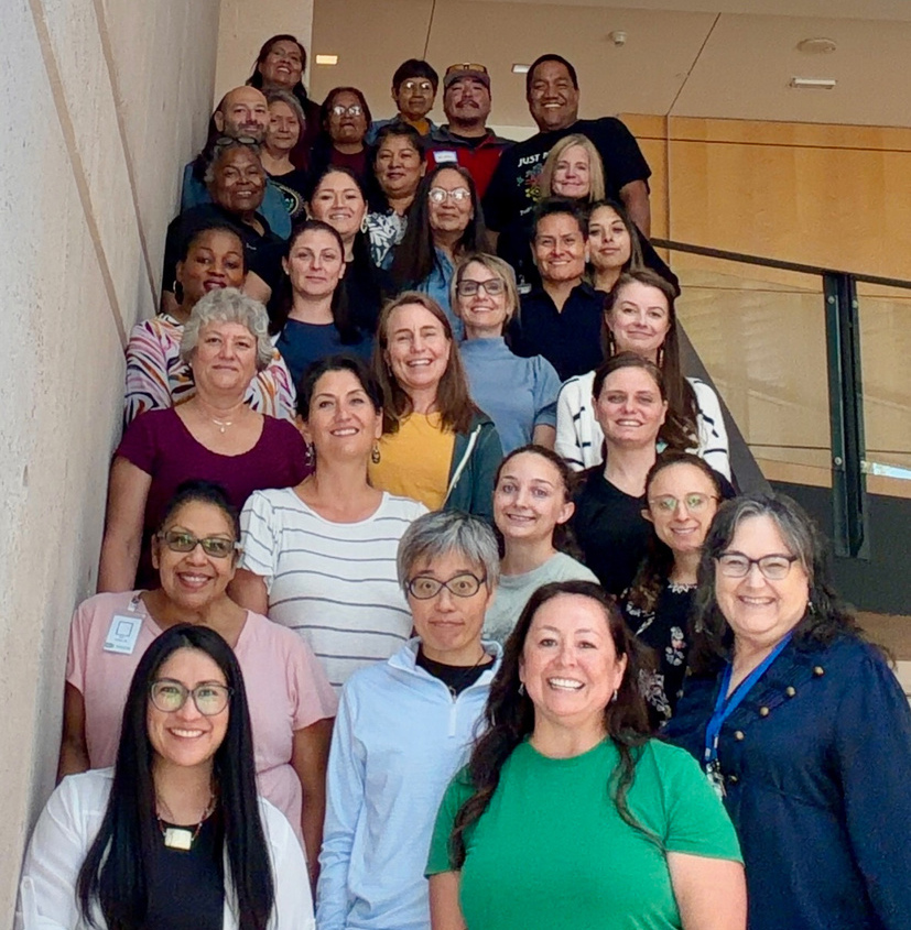 A group of about 20 people pose on stairs in Phoenix