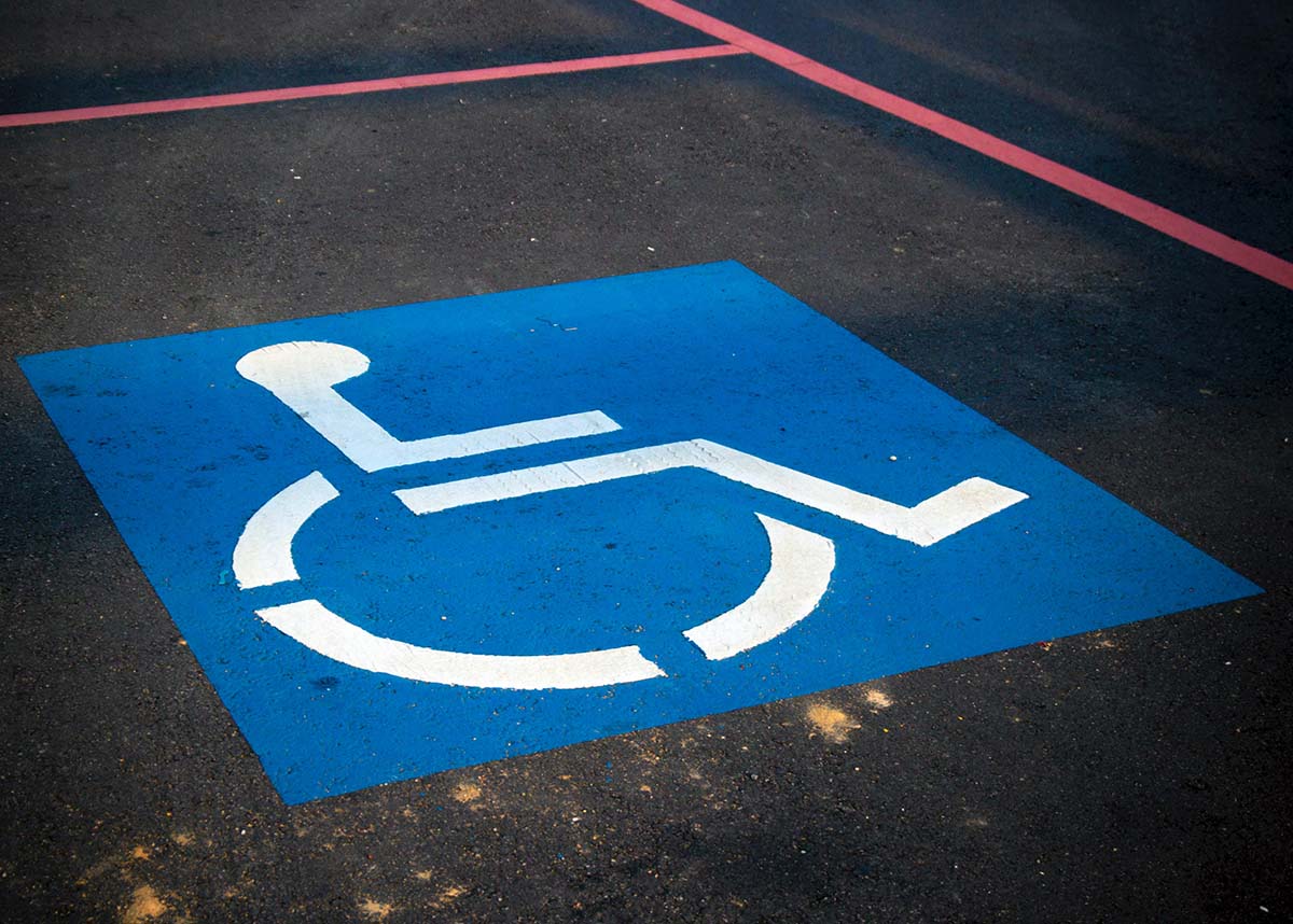 close up of a handicap symbol on a parking spot