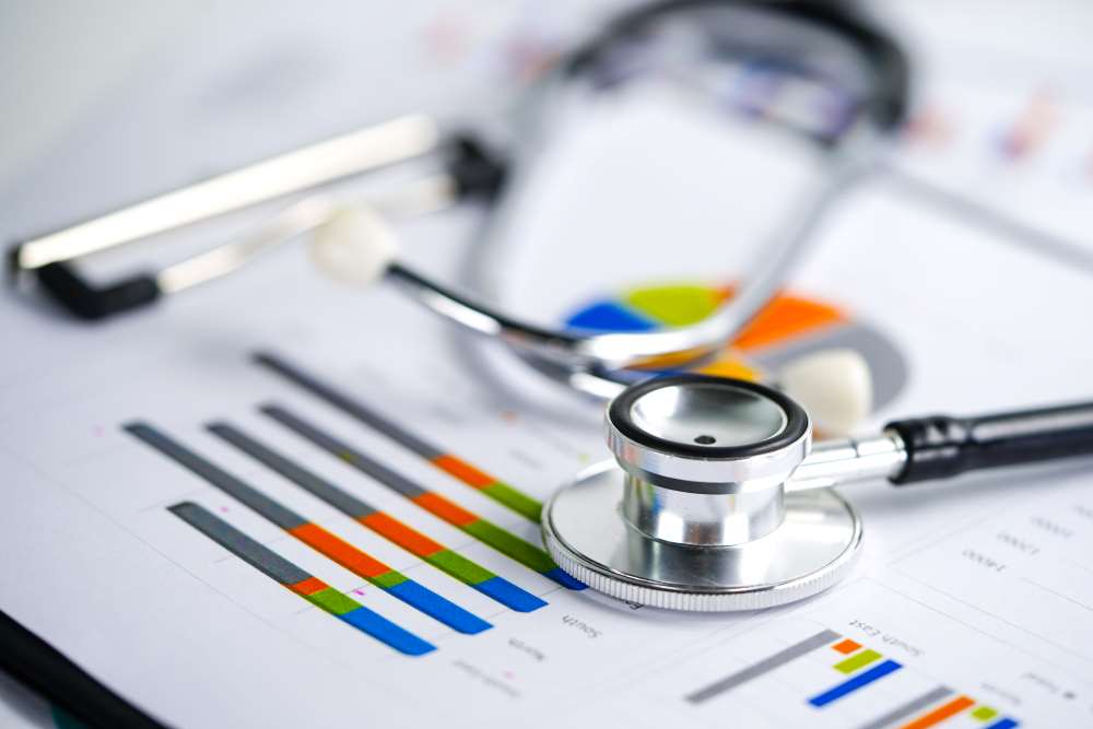Stethoscope laying on top of charts of data