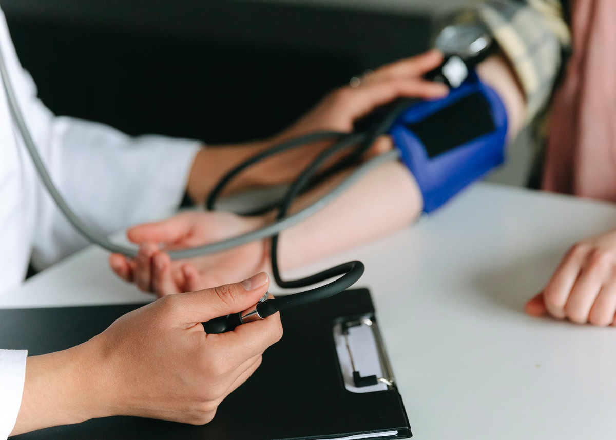 Health care professional measuring blood pressure