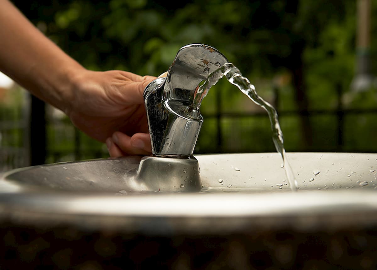 Person using drinking fountain