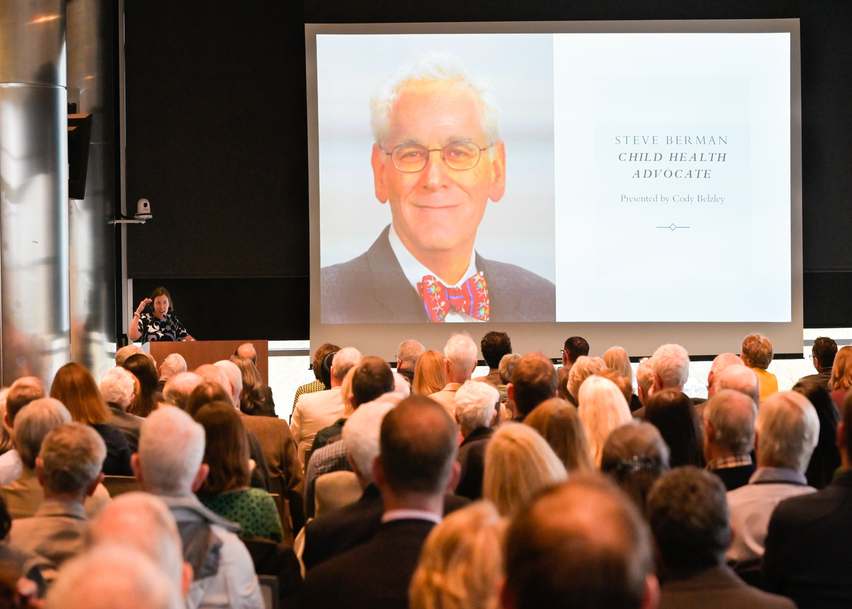 ColoradoSPH Steve Berman Tribute event, with presenter standing in front of audience and large display