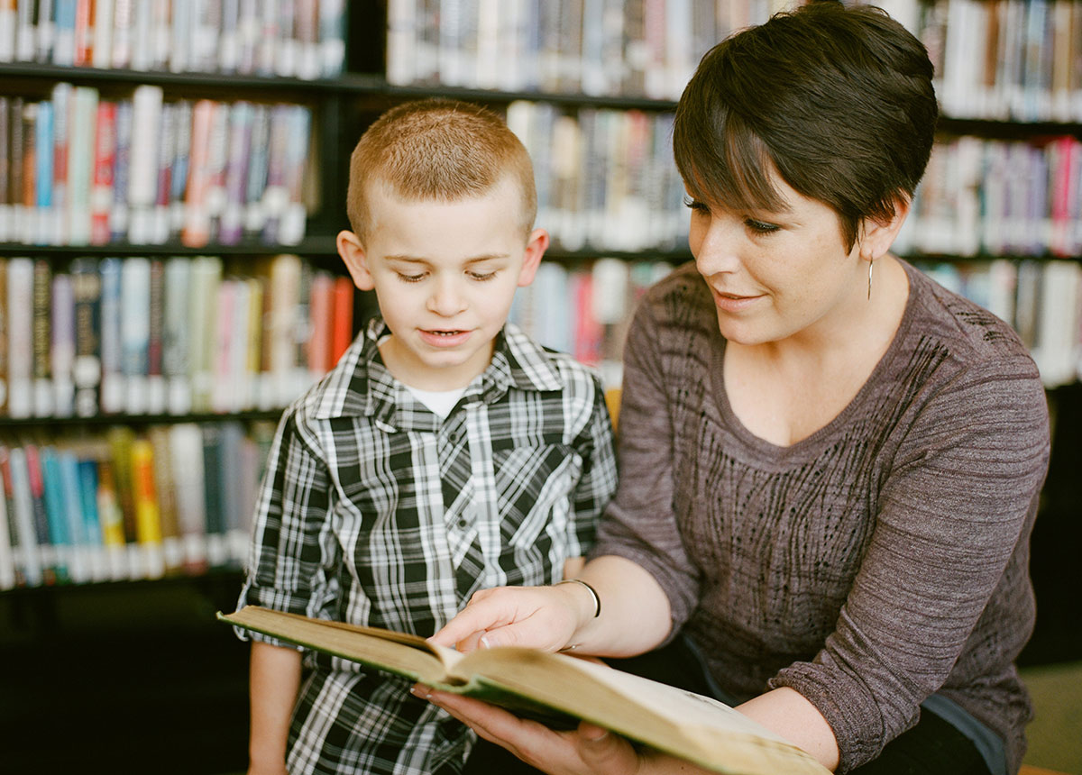 woman and child looking at a book together