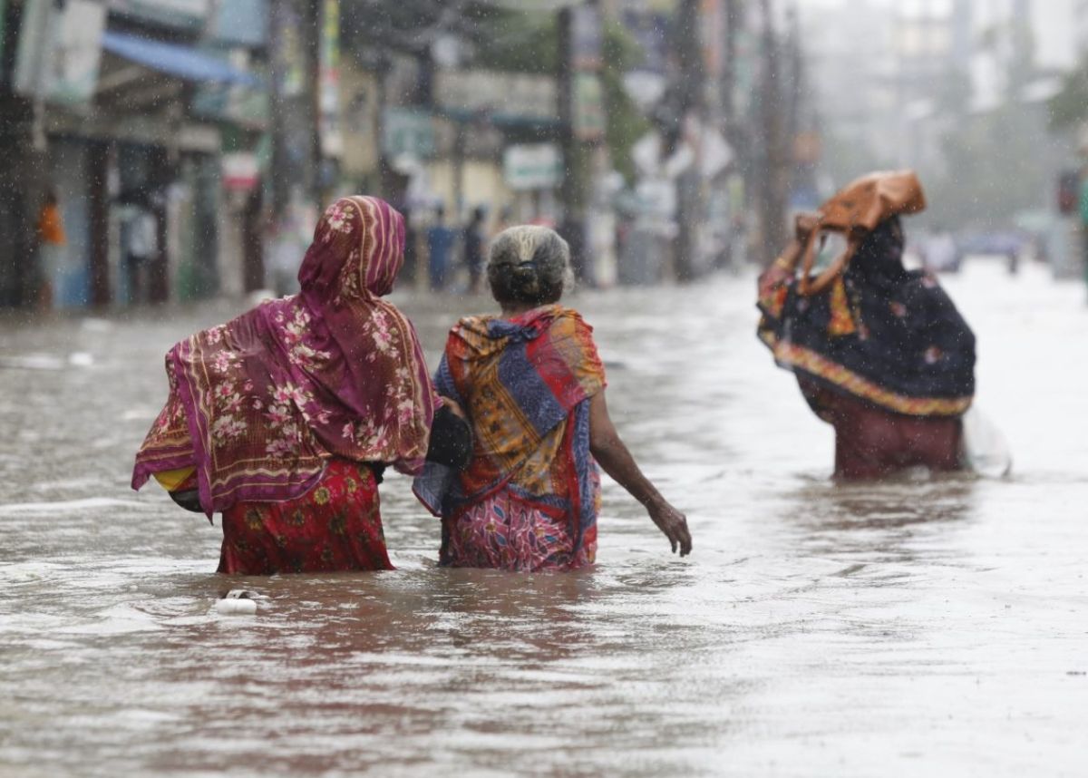 women walking through flood