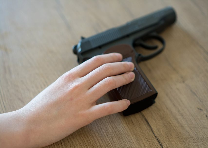 Person with their hand on a pistol