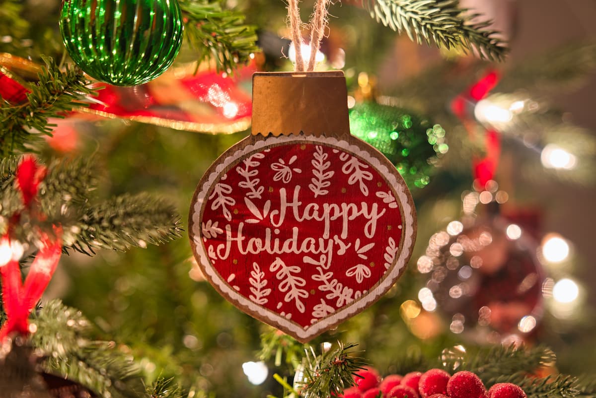 Happy Holidays ornament on a tree