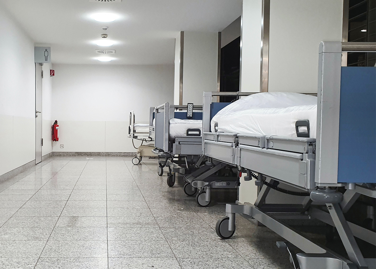 Hallway in hospital with beds lined on the side