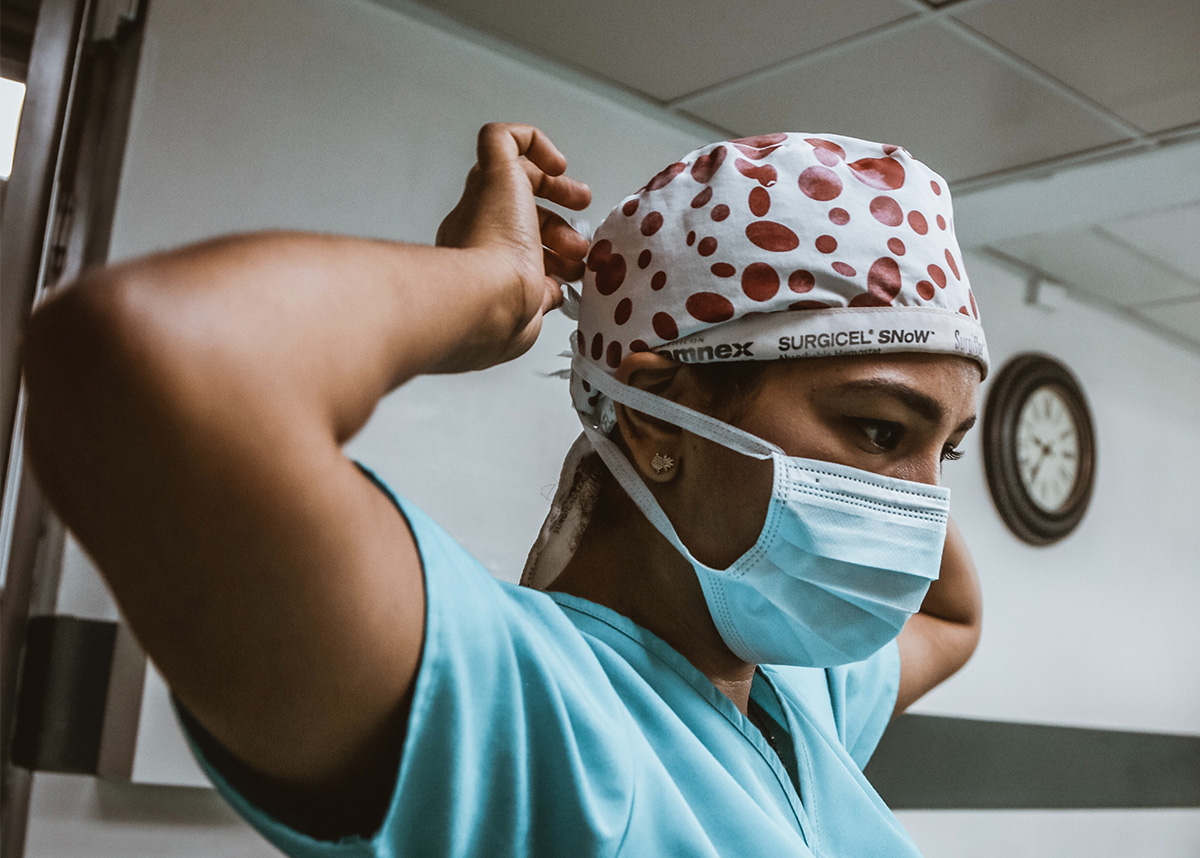 Healthcare worker adjusting mask