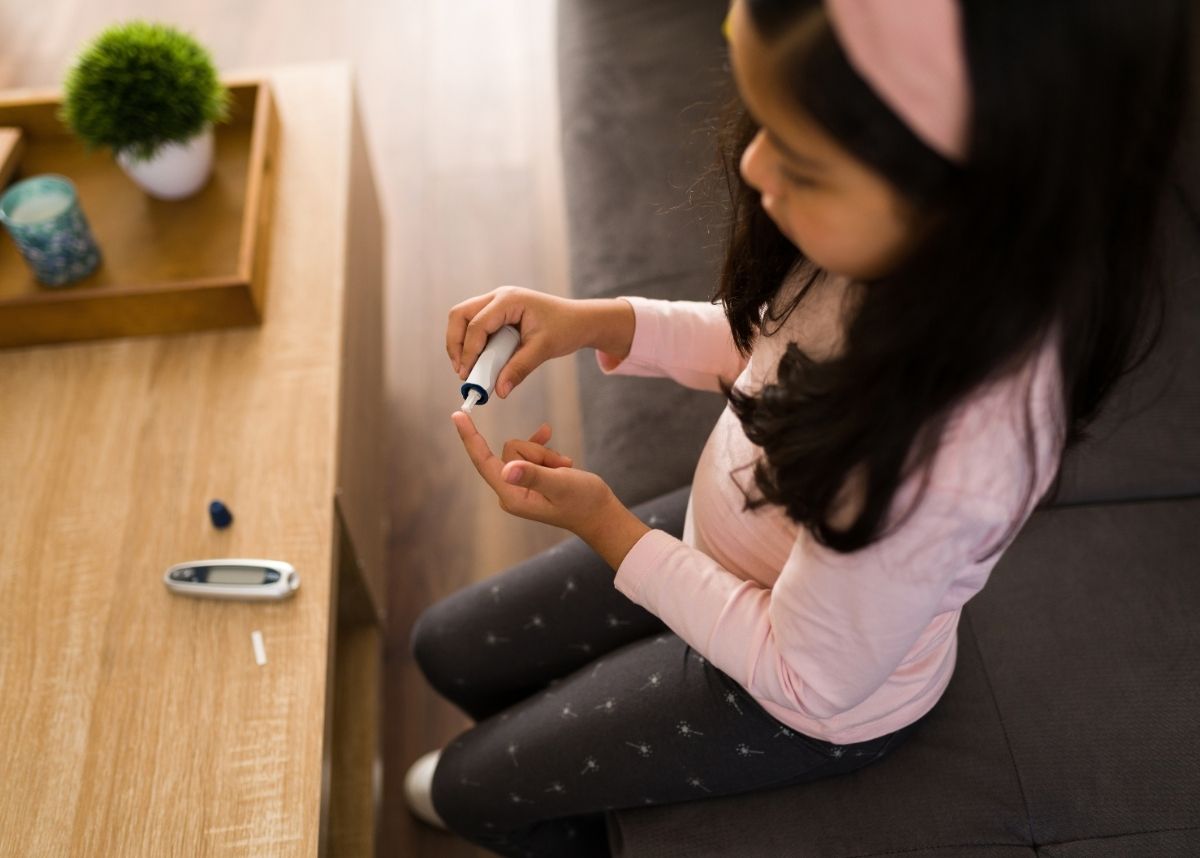 Little girl testing her glucose levels