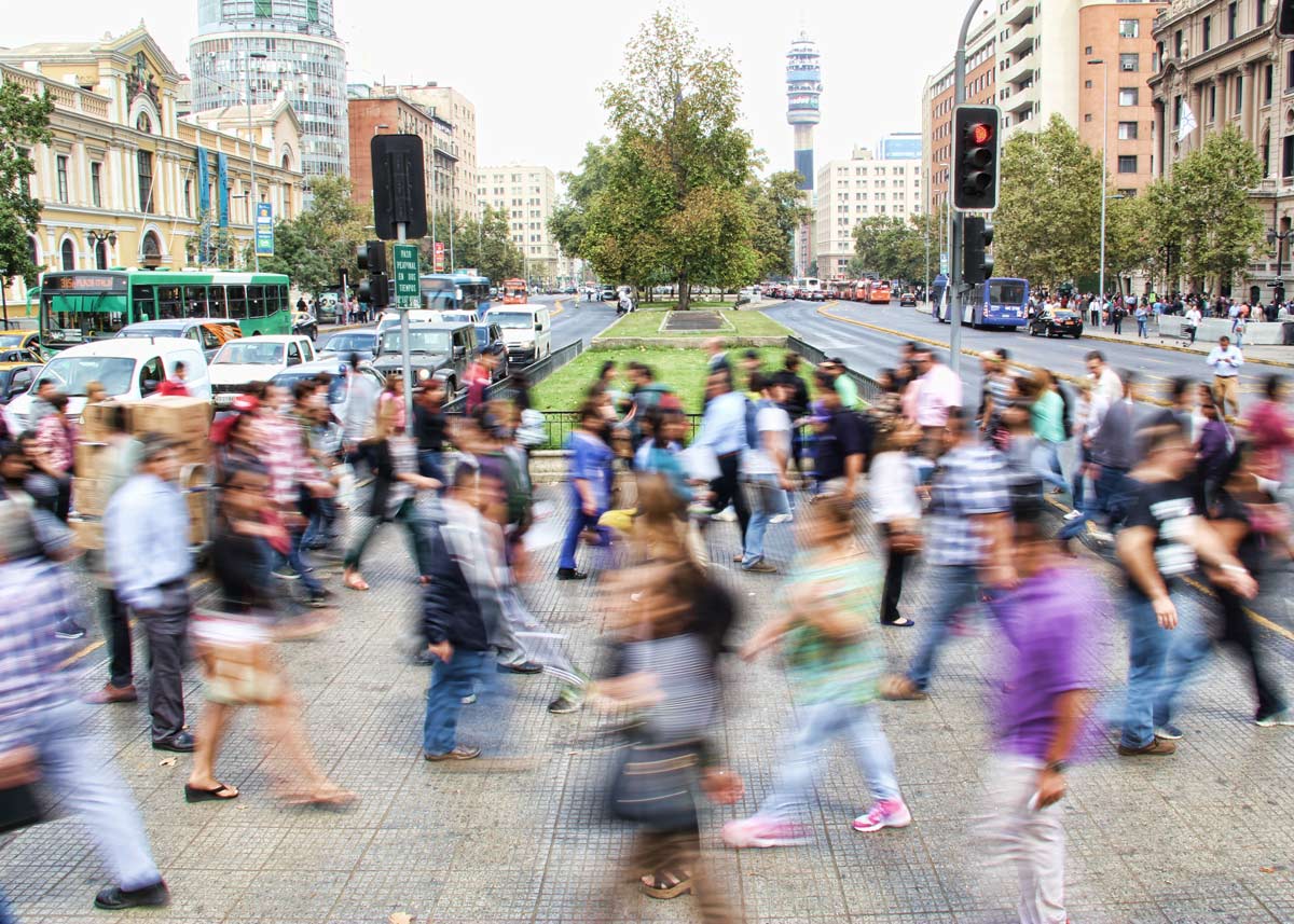 blurry photo of busy streets with people walking
