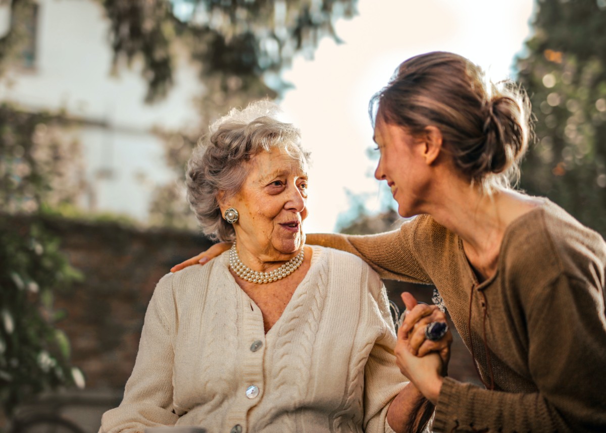 Older adult woman chatting with a young woman