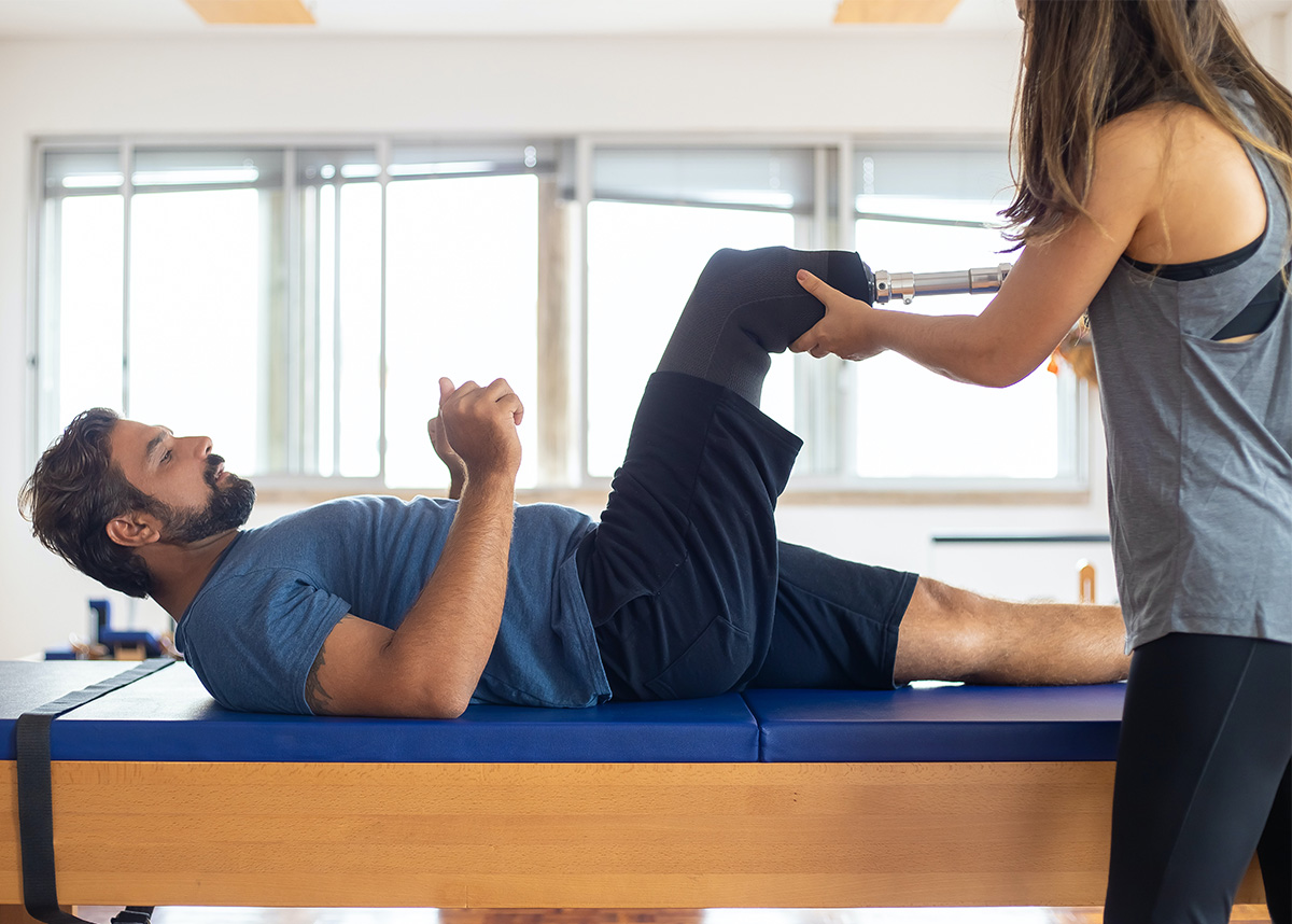 Physical therapist stretching patients leg