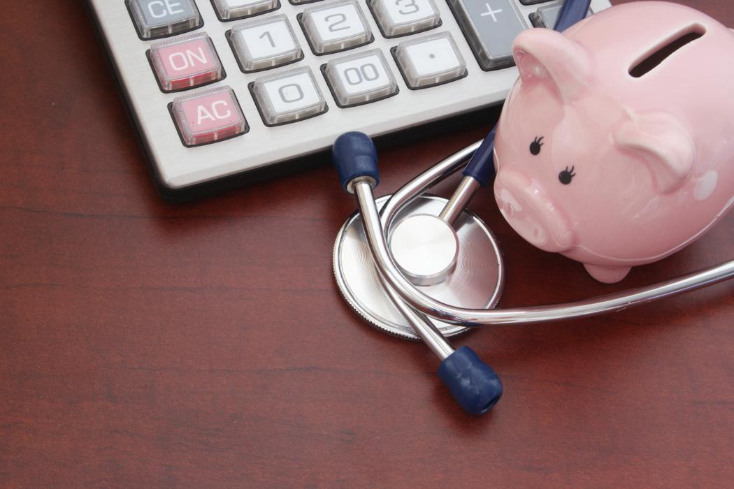 A piggy bank, calculator, and stethoscope.