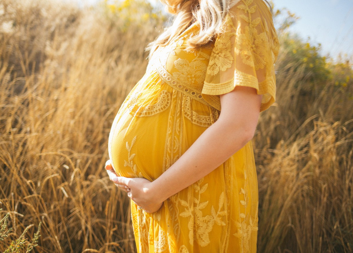 pregnant woman holding stomach