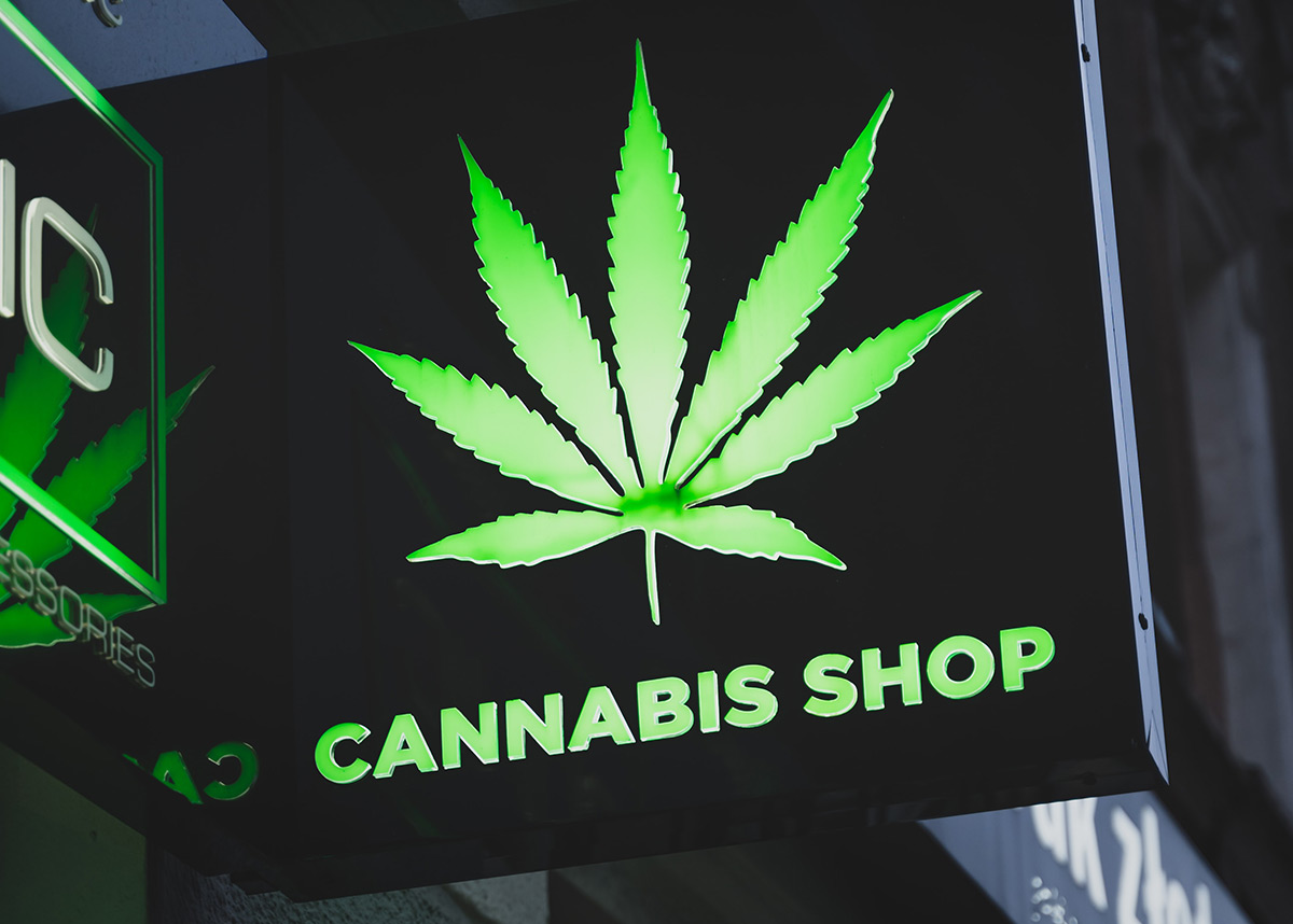 neon sign that reads, "cannabis shop"