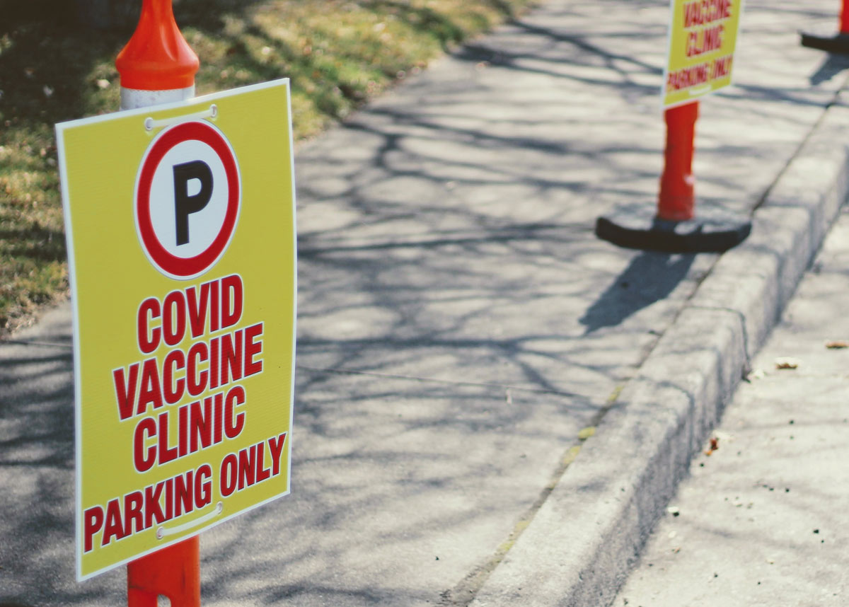 parking lot with sign that reads, "COVID vaccine clinic parking only"