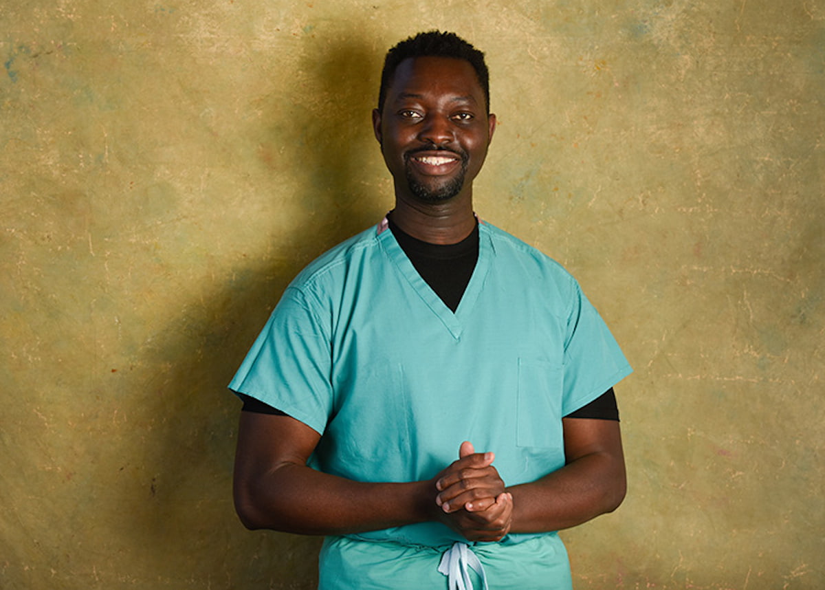 Doctor Kweku Hazel smiling with hands clasped together