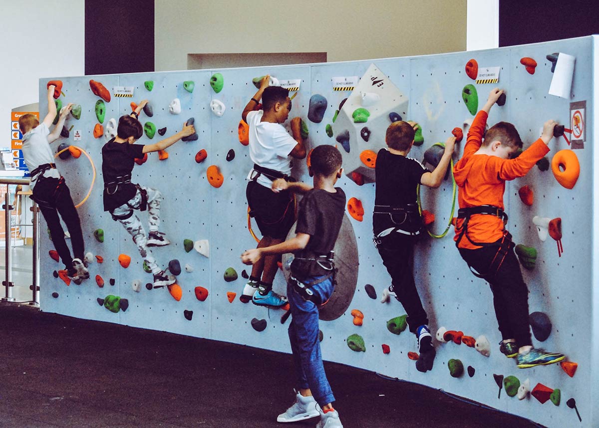 group of kids rock climbing