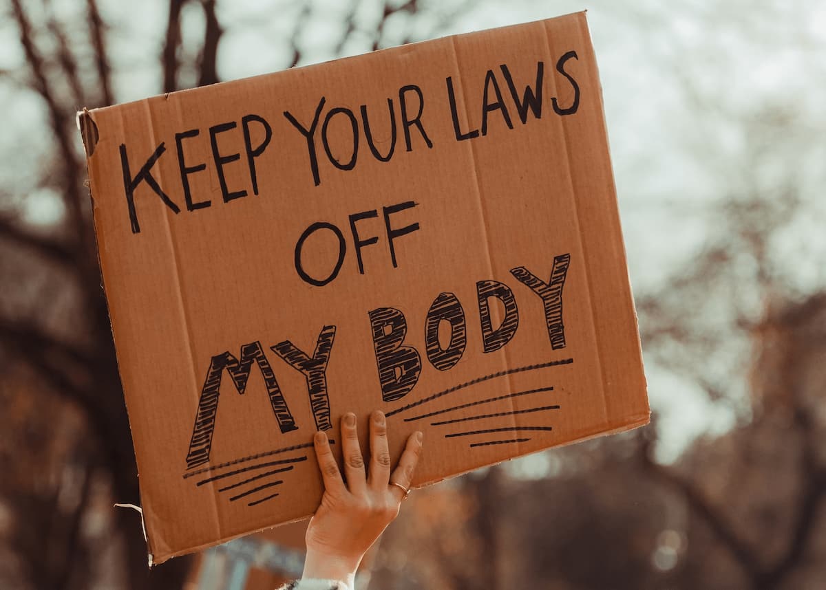Protest sign saying "keep your laws off my body"