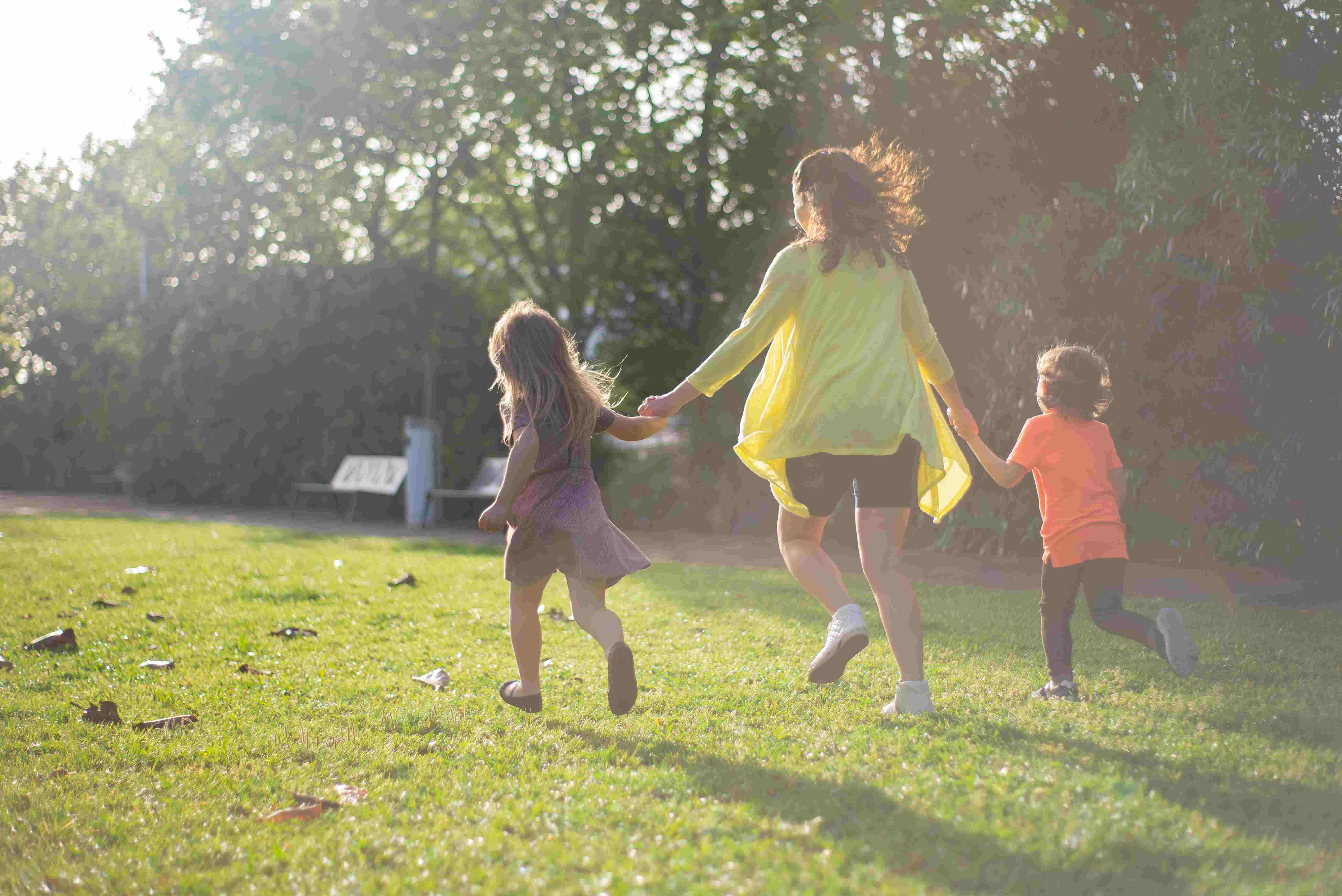 A women with two children in a field