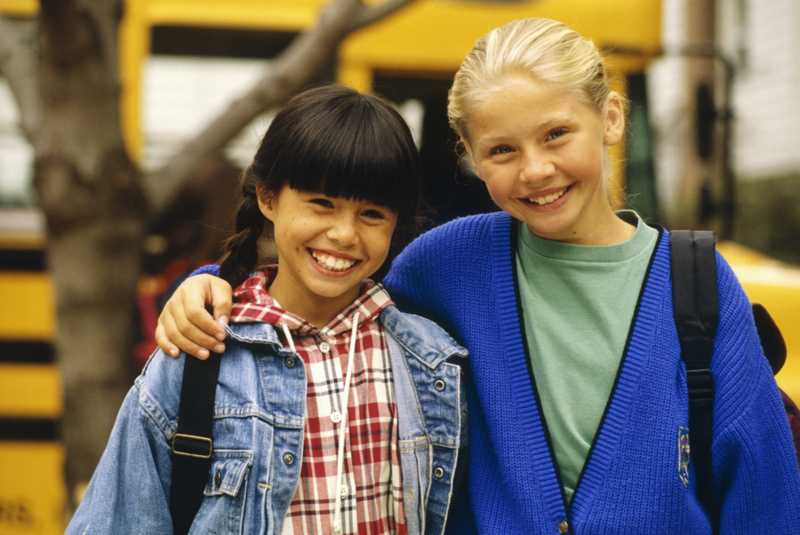 Two girls in front of bus
