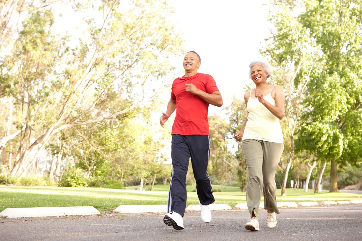 an older man and woman walking outdoors