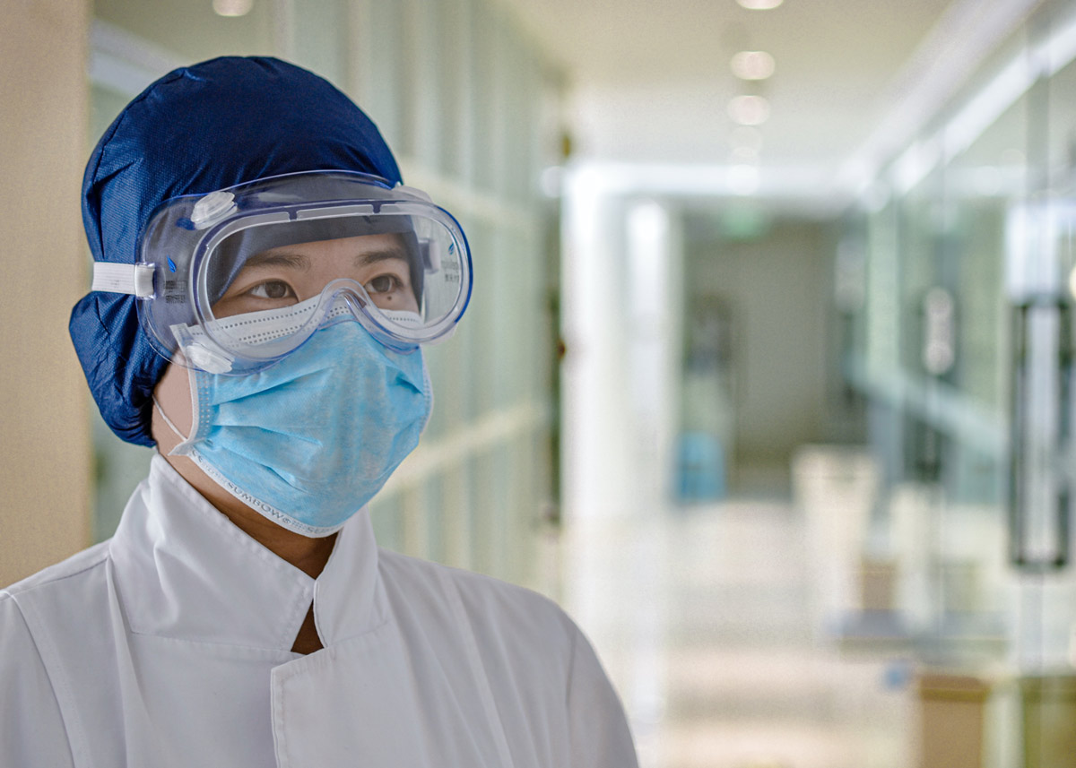 healthcare worker wearing googles and a mask