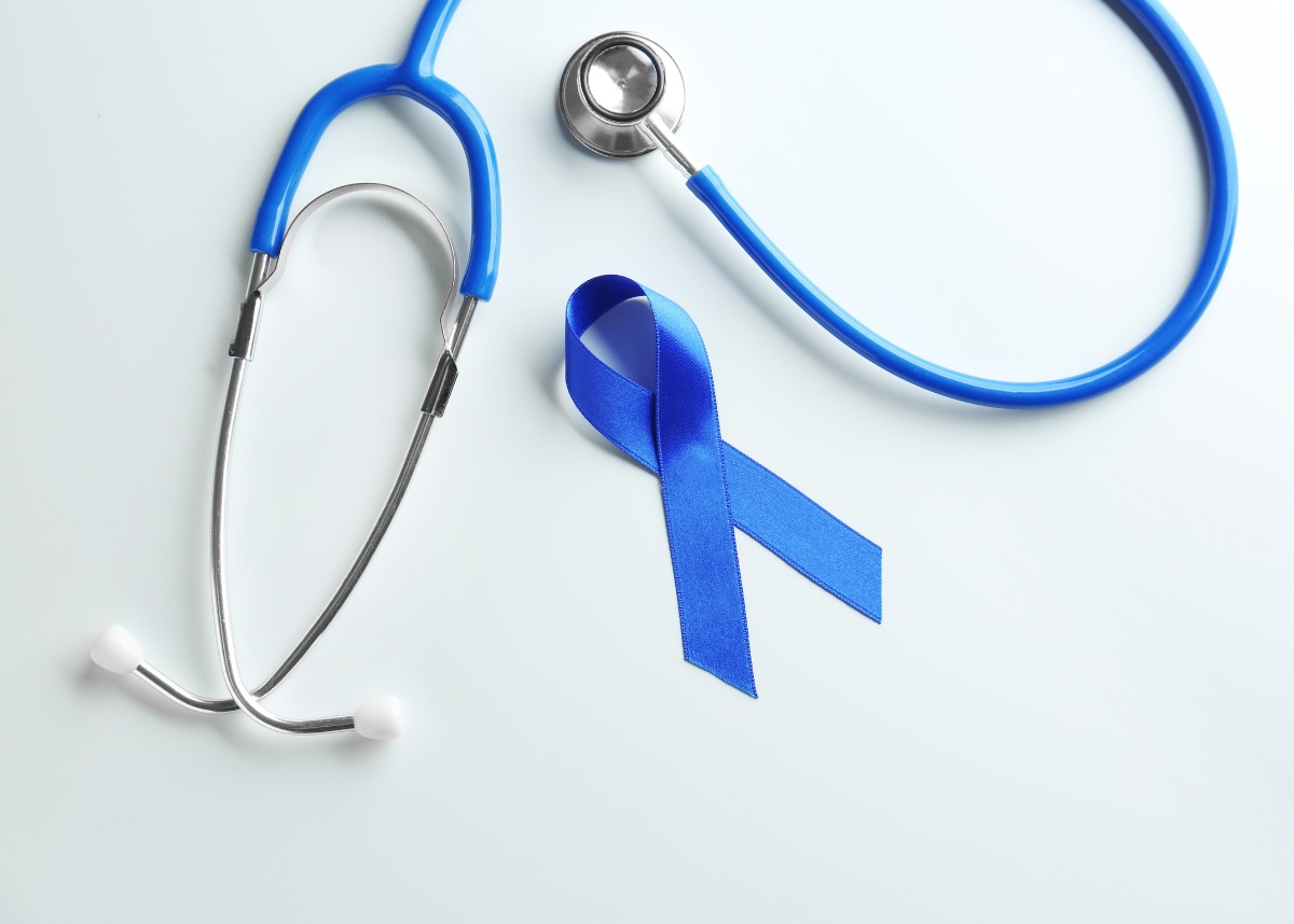 Blue ribbon and stethoscope on white background