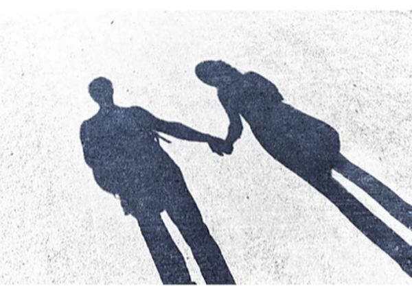 shadows of man and woman holding hands
