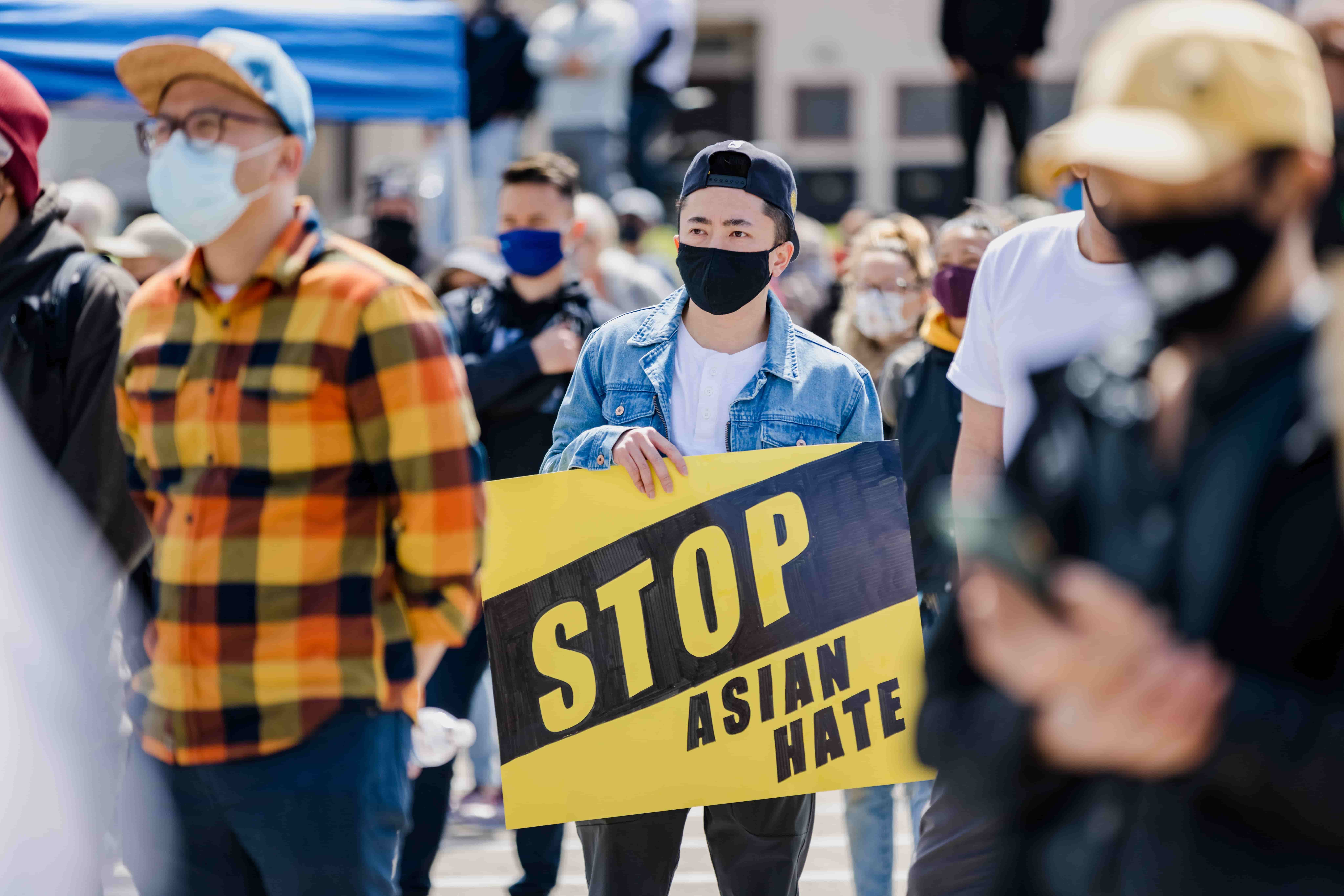 Man hold sign reading stop asian hate