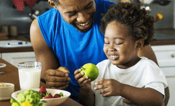 dad teaching daughter about healthy food